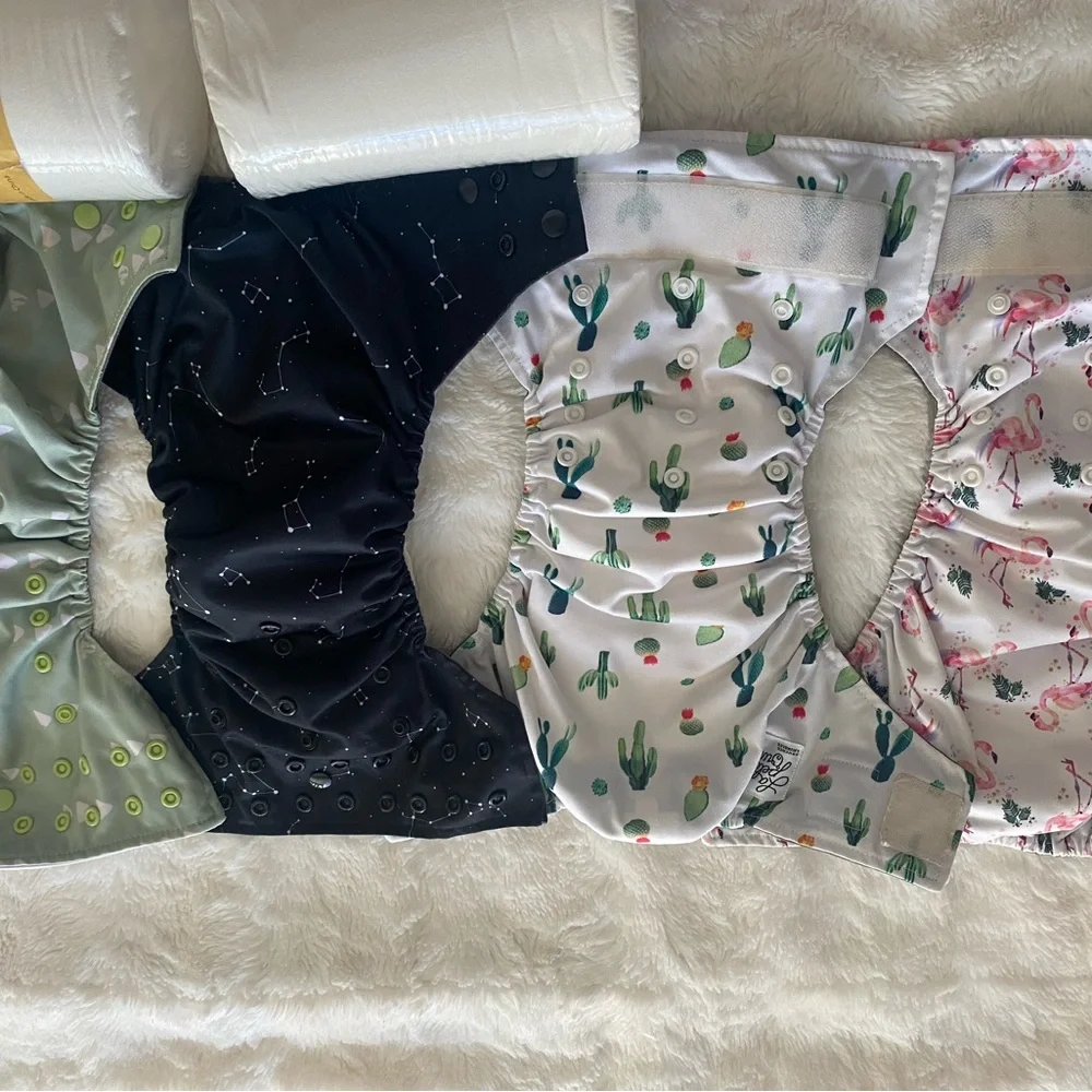 17 pocket cloth diapers + inserts, liners, and storage bags